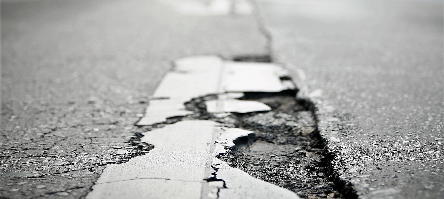 Schlaglöcher auf einer Straße.