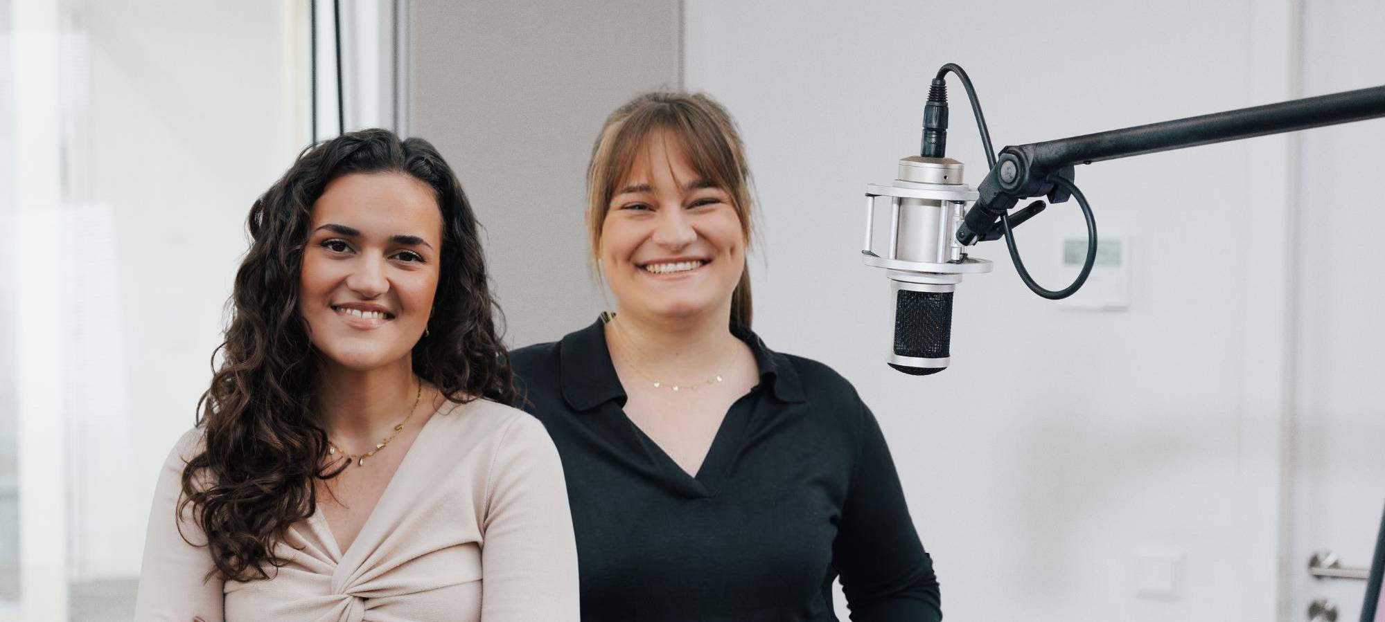Yara Safear und Lia Staniewski stehen im Studio, neben ihnen ein Mikrofon